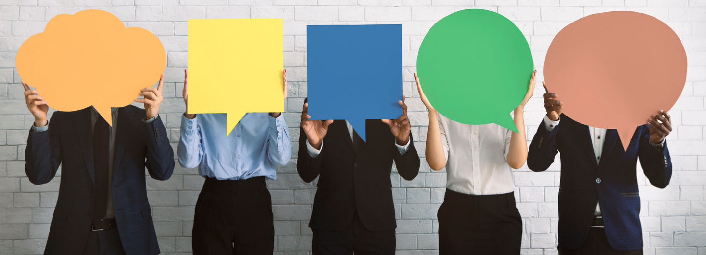 The image shows five people holding speech bubbles in front of their face in different colours