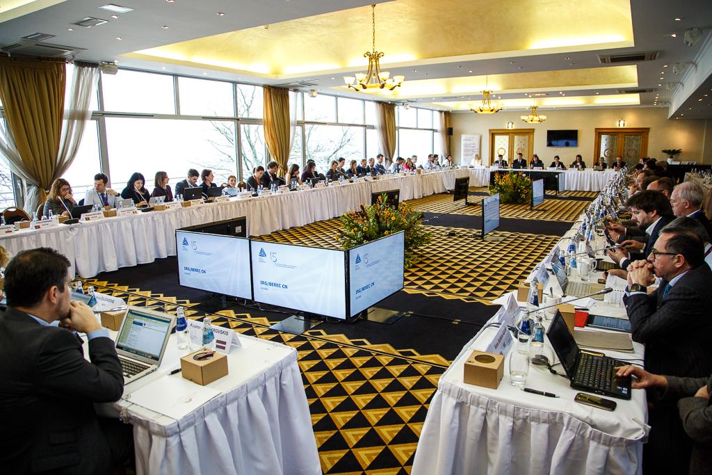 The image shows multiple participants sitting at a U-shaped table group