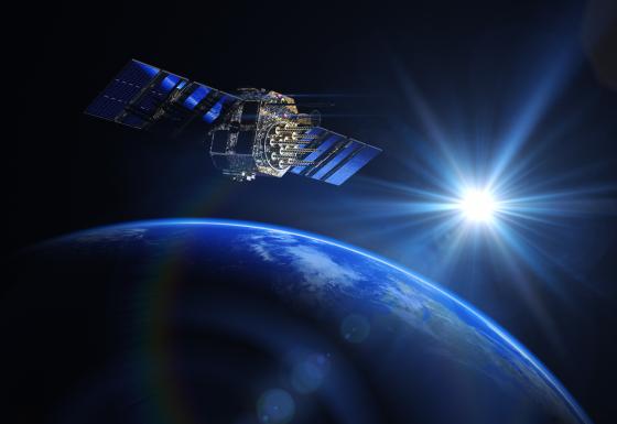 The image shows a satellite in the atmosphere with the earth in the background.